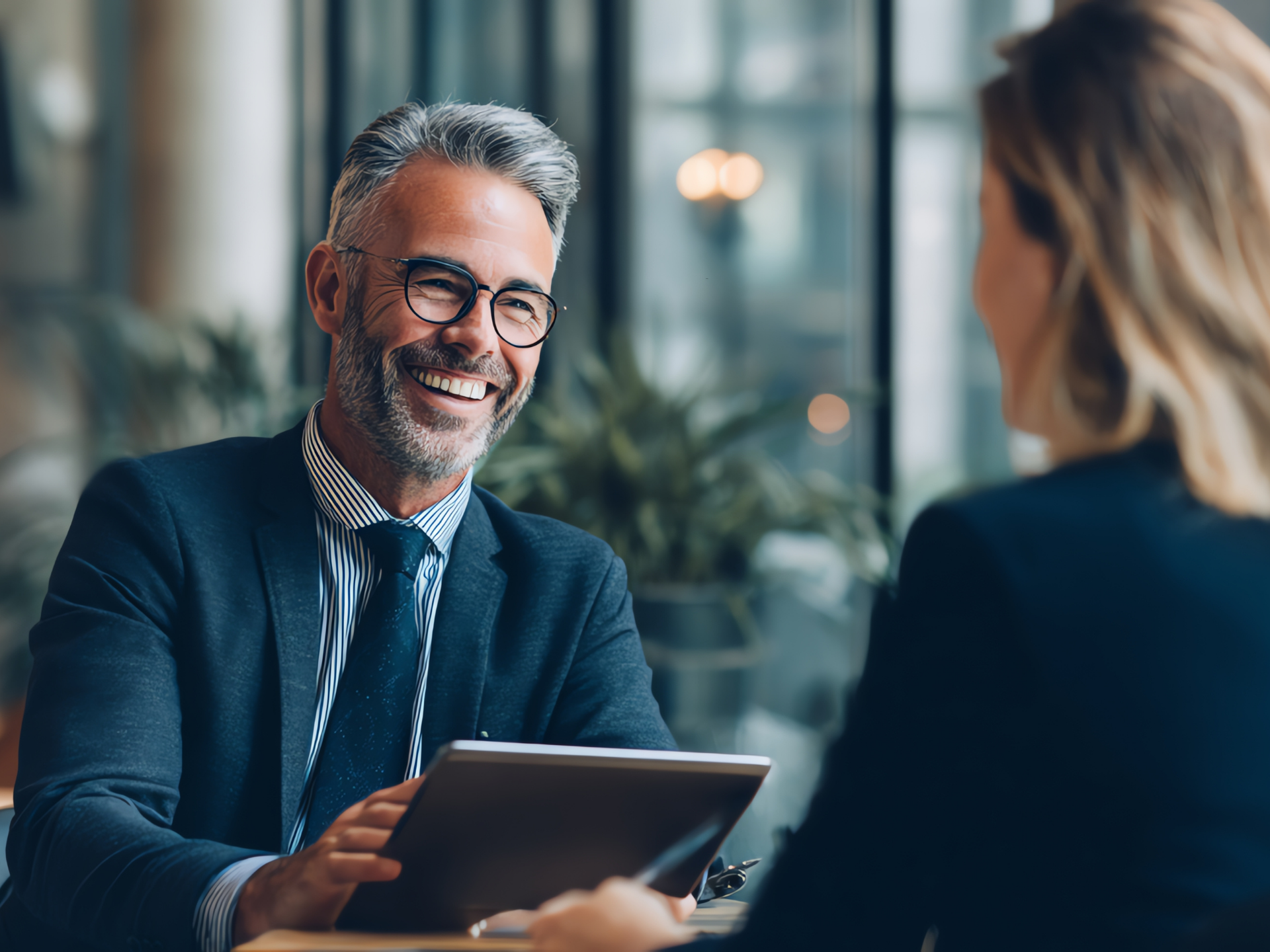 Professional discussing Managed IT Services with colleague in modern office