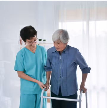 a part time caregiver aiding an elderly with walking