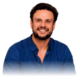 Smiling bearded man with dark hair wearing a blue button-up shirt against a transparent background.