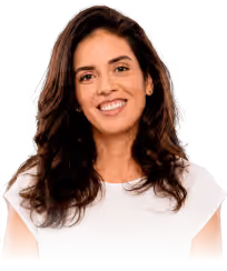 Smiling woman with long dark hair wearing a white shirt on a white background.