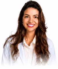 Smiling woman with long curly brown hair wearing a white coat and beige blouse.