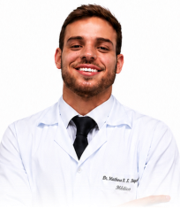 Smiling male doctor wearing a white coat and black tie against a white background.