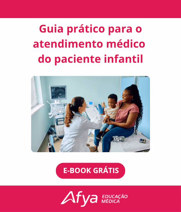 Doctor giving a high-five to a smiling child sitting on a woman’s lap in a medical exam room.
