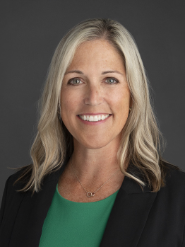 Portrait of professional woman with blond, shoulder length hair.