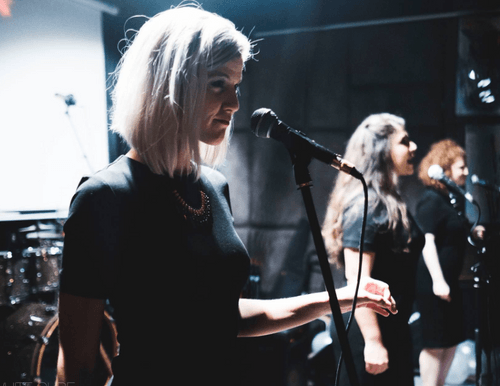 Heather singing on stage.