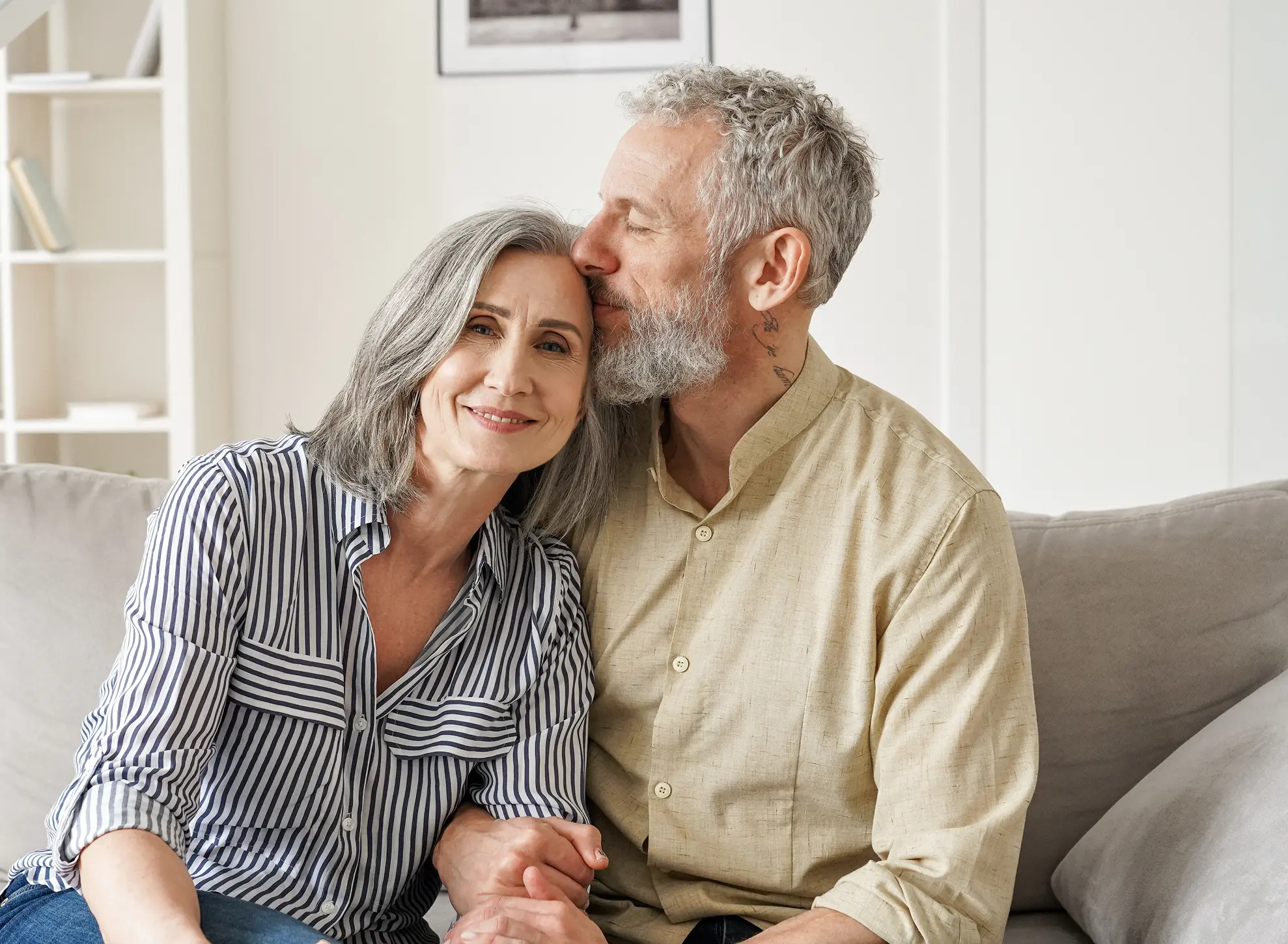 A man and a woman sitting on a couch.