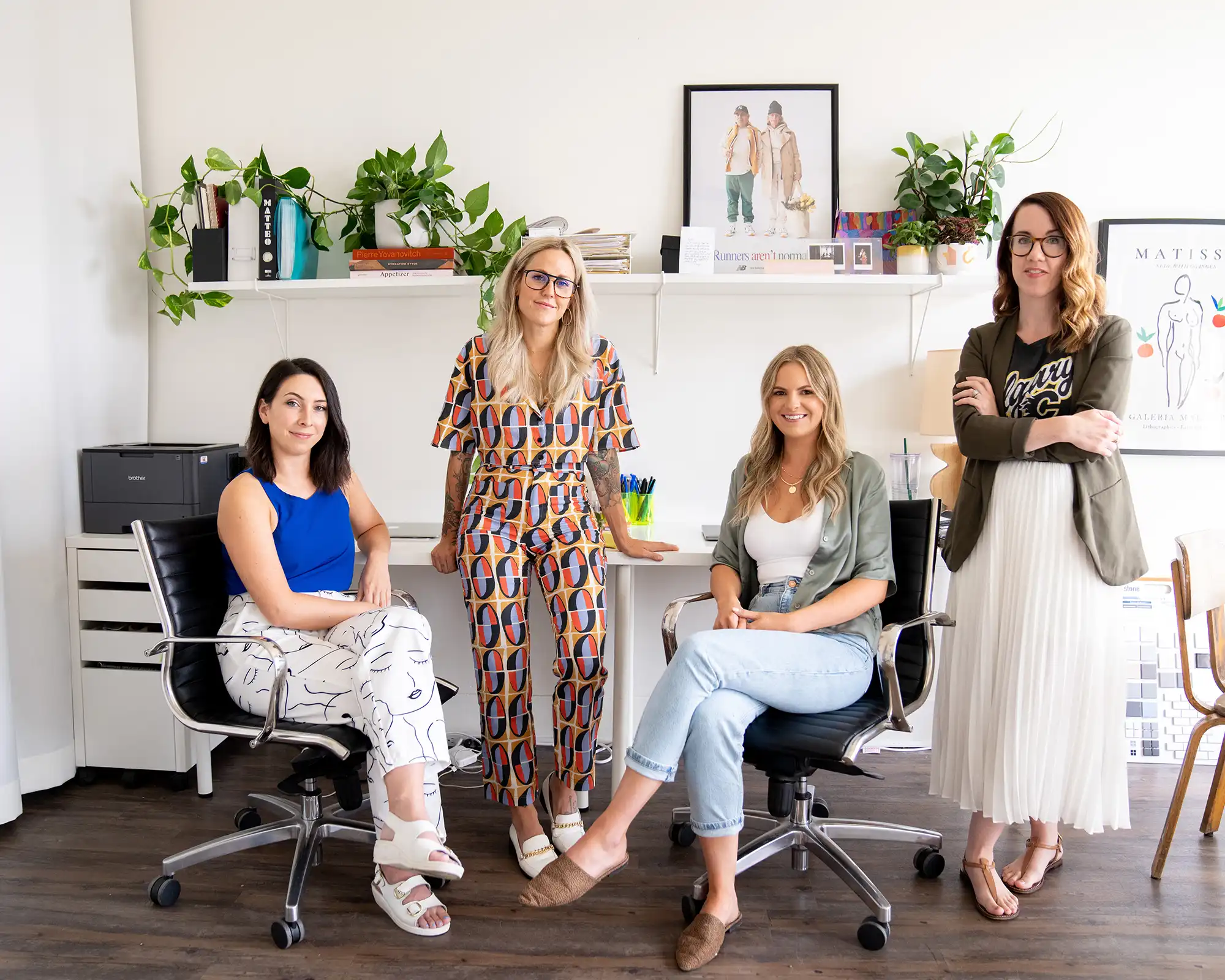 Team photo of Interior Design Team posing for photo in office.