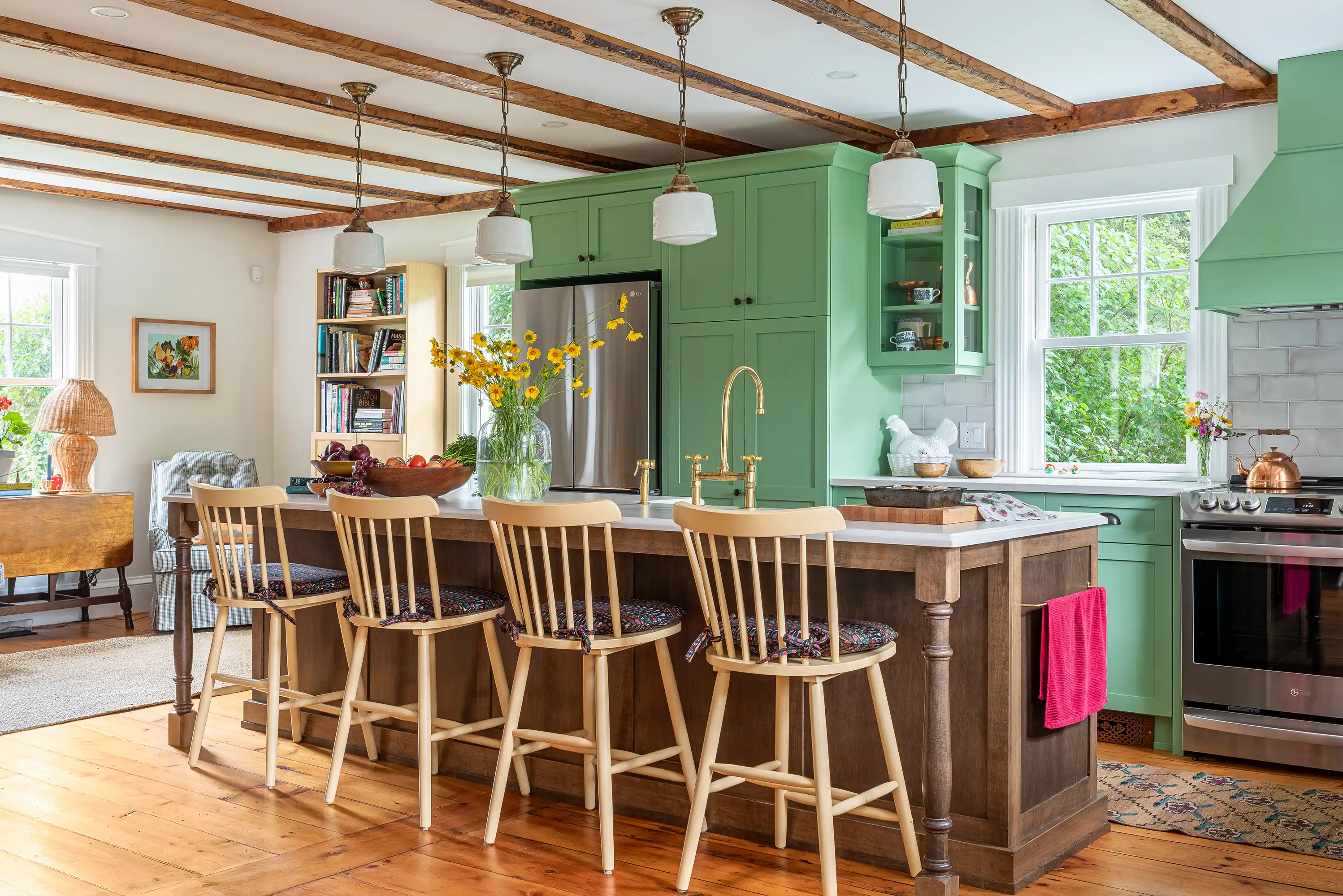 Interior Design renovation of beautiful green kitchen with an island and high chairs.
