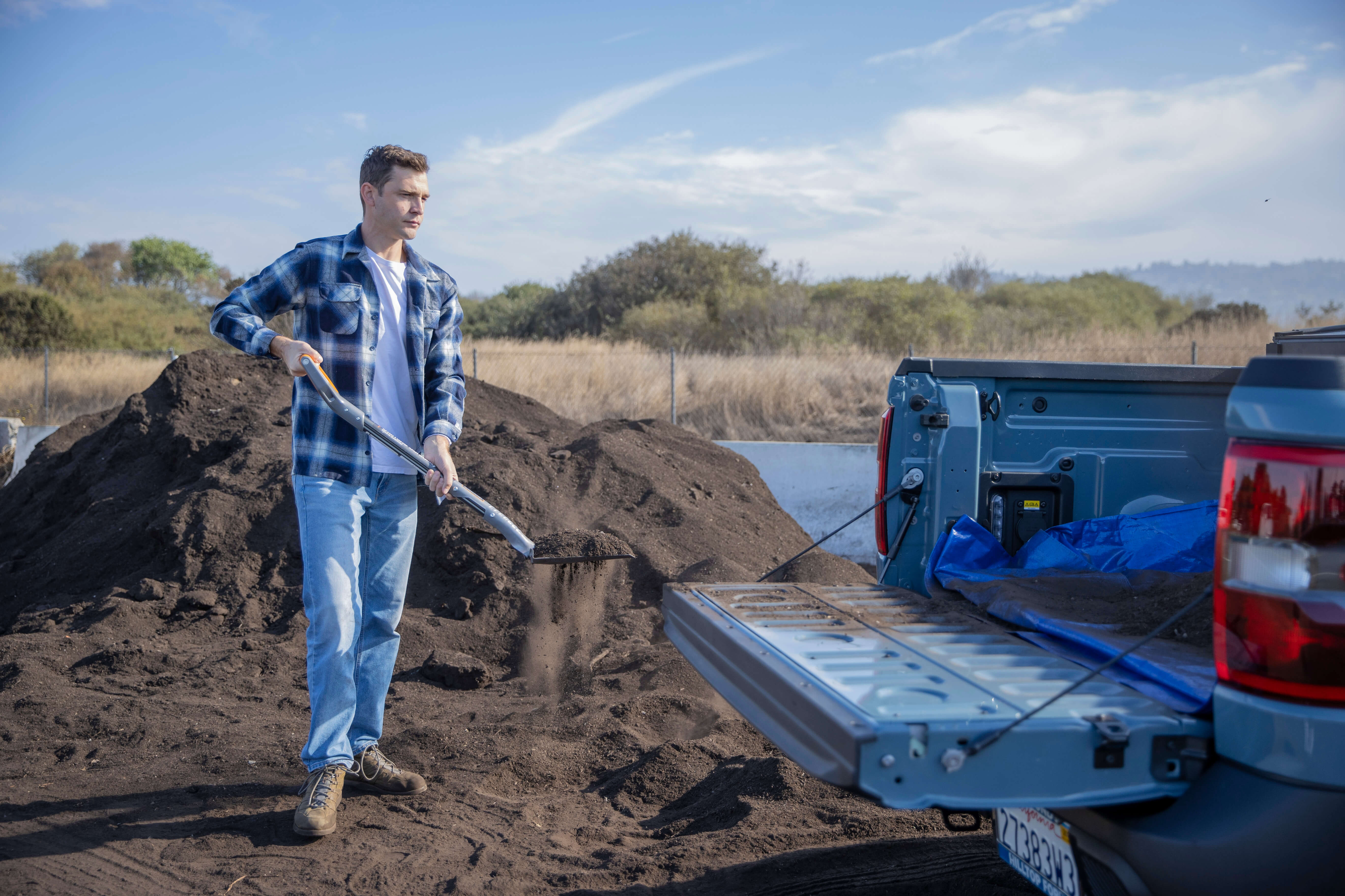 Resident scoops manure into truck bed