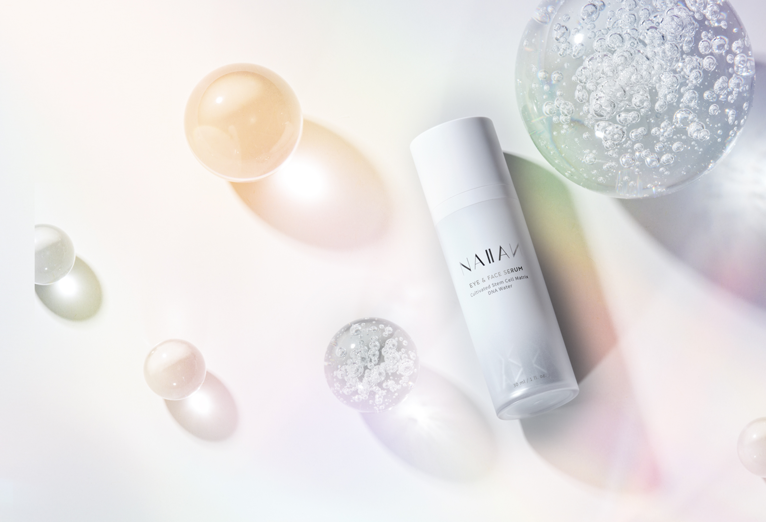 Main banner featuring Naiian Eye & Face Serum, designed by Rhee Design, displayed with glass spheres on a soft iridescent background.