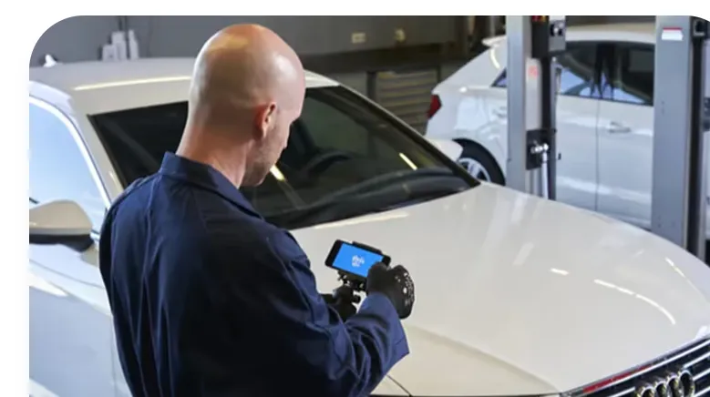 Service advisor showing a vehicle inspection on video in the workshop