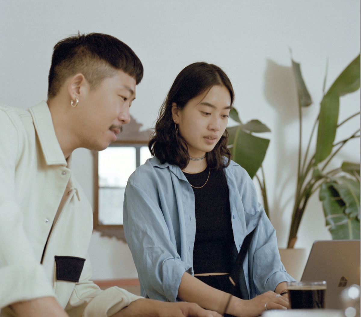 Two colleagues reviewing a submission together on a laptop
