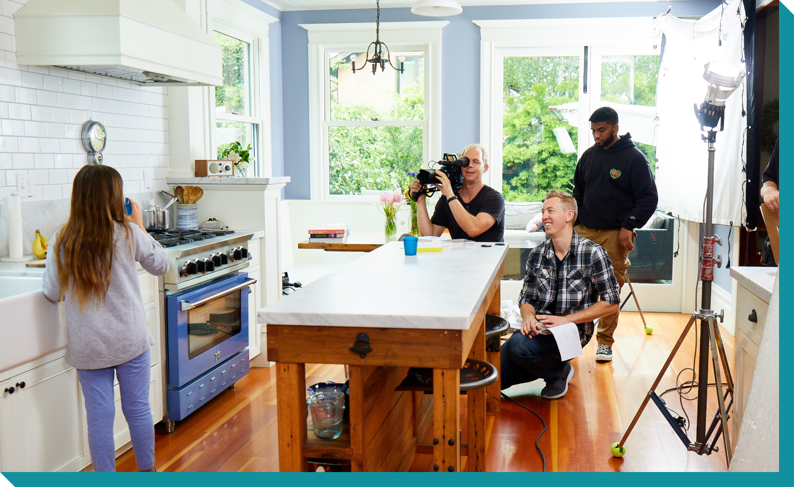Behind the scenes of production, Doug directs little girl in kitchen