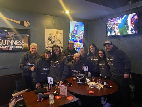 A group of people standing around a table.
