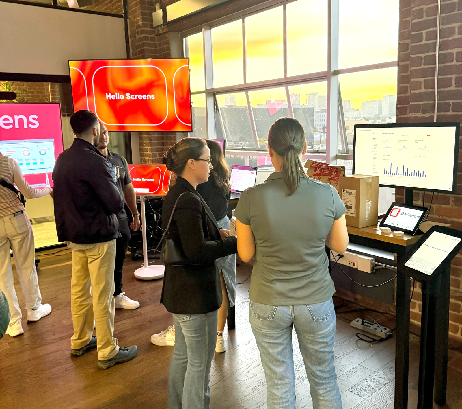 People standing in front of a wall of screens