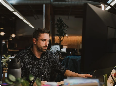 Image of a person sitting at a computer
