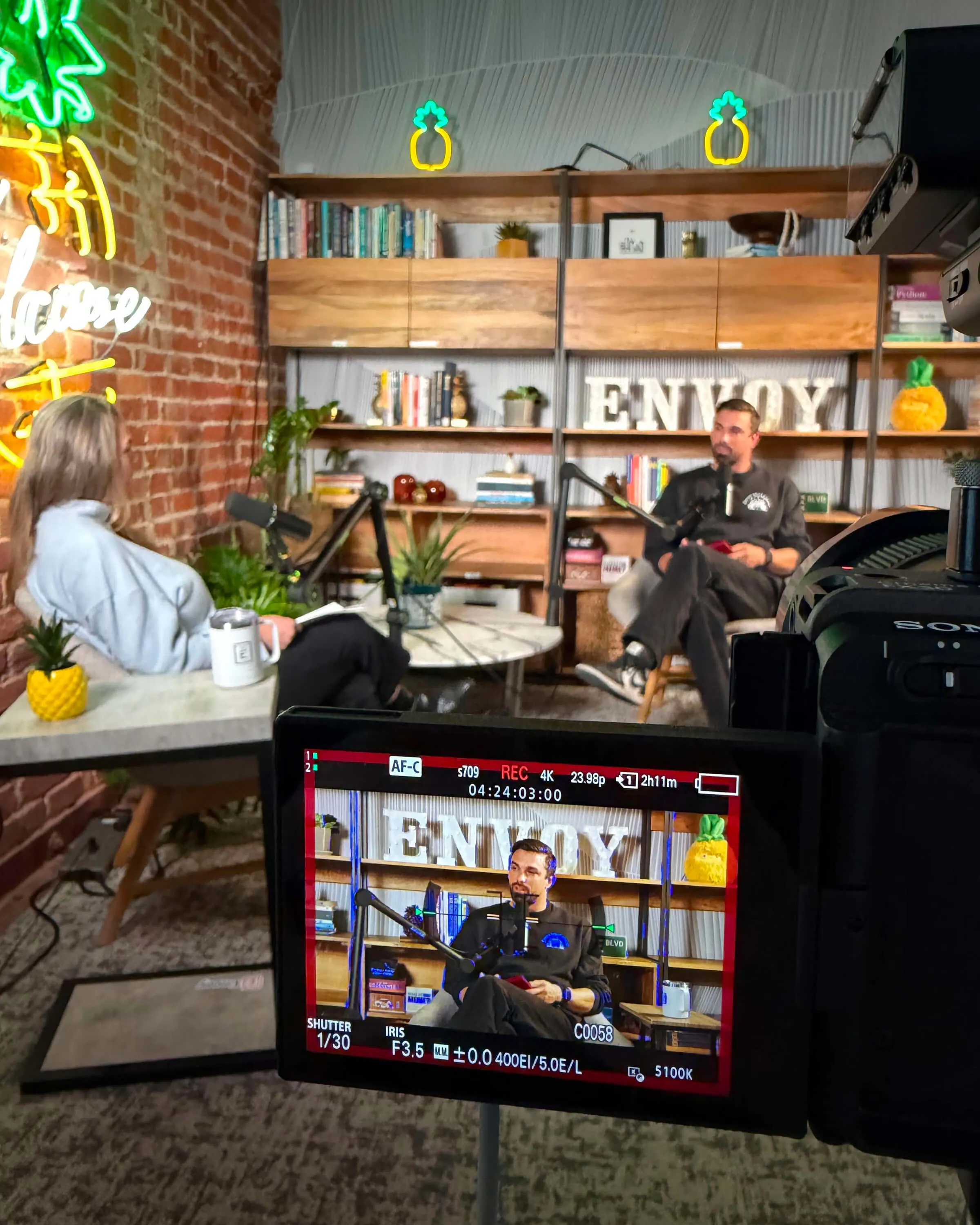 A view a camera focused on Matt Tverberg recording a podcast.