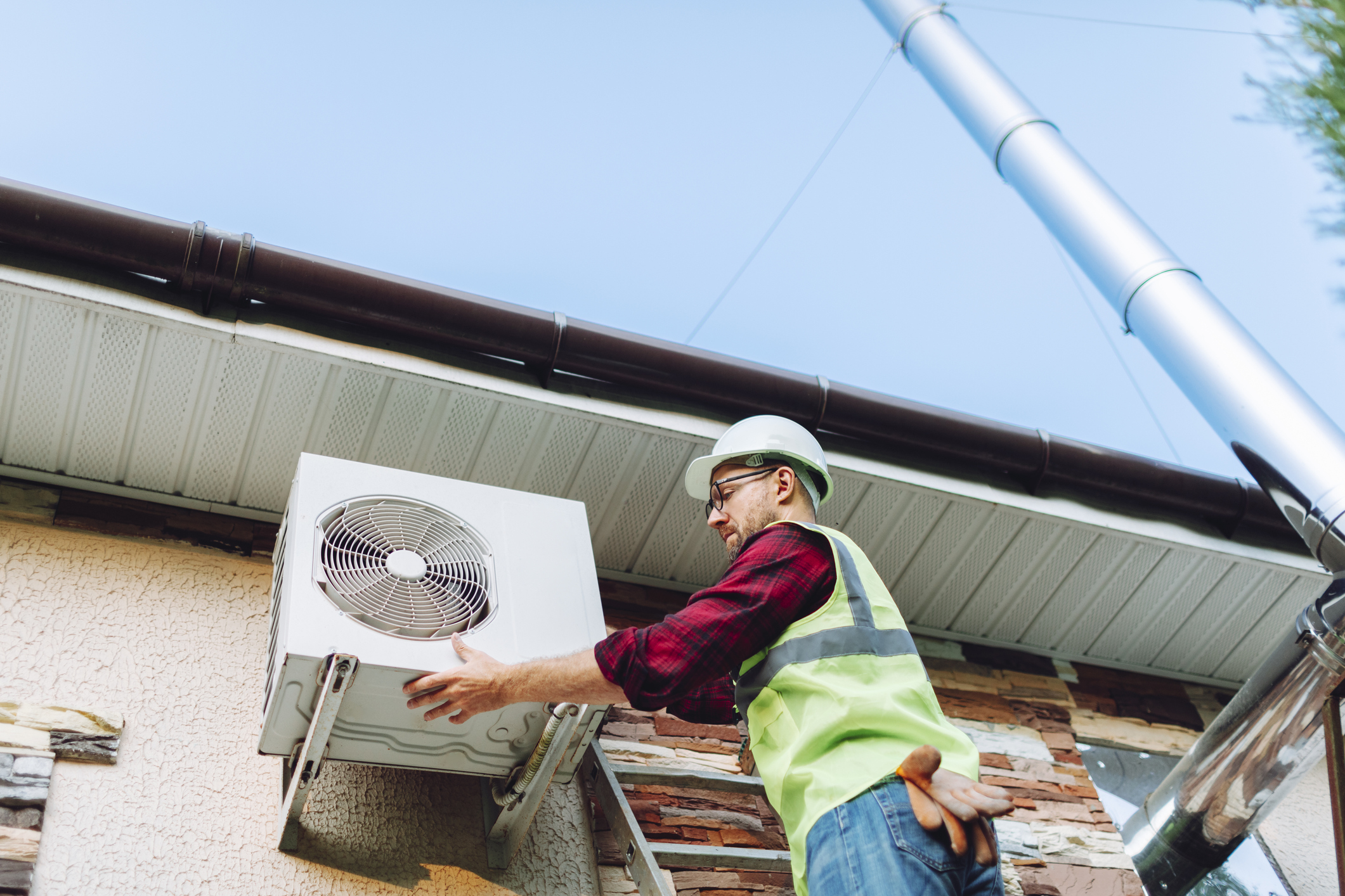 Our HVAC technician hard at work installing a new air conditioner.