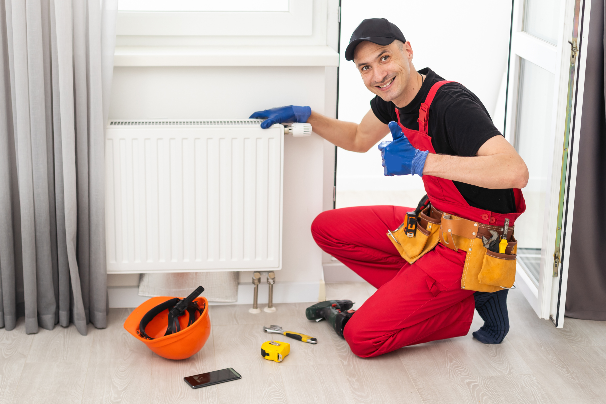 Technician diligently repairs a heating radiator.