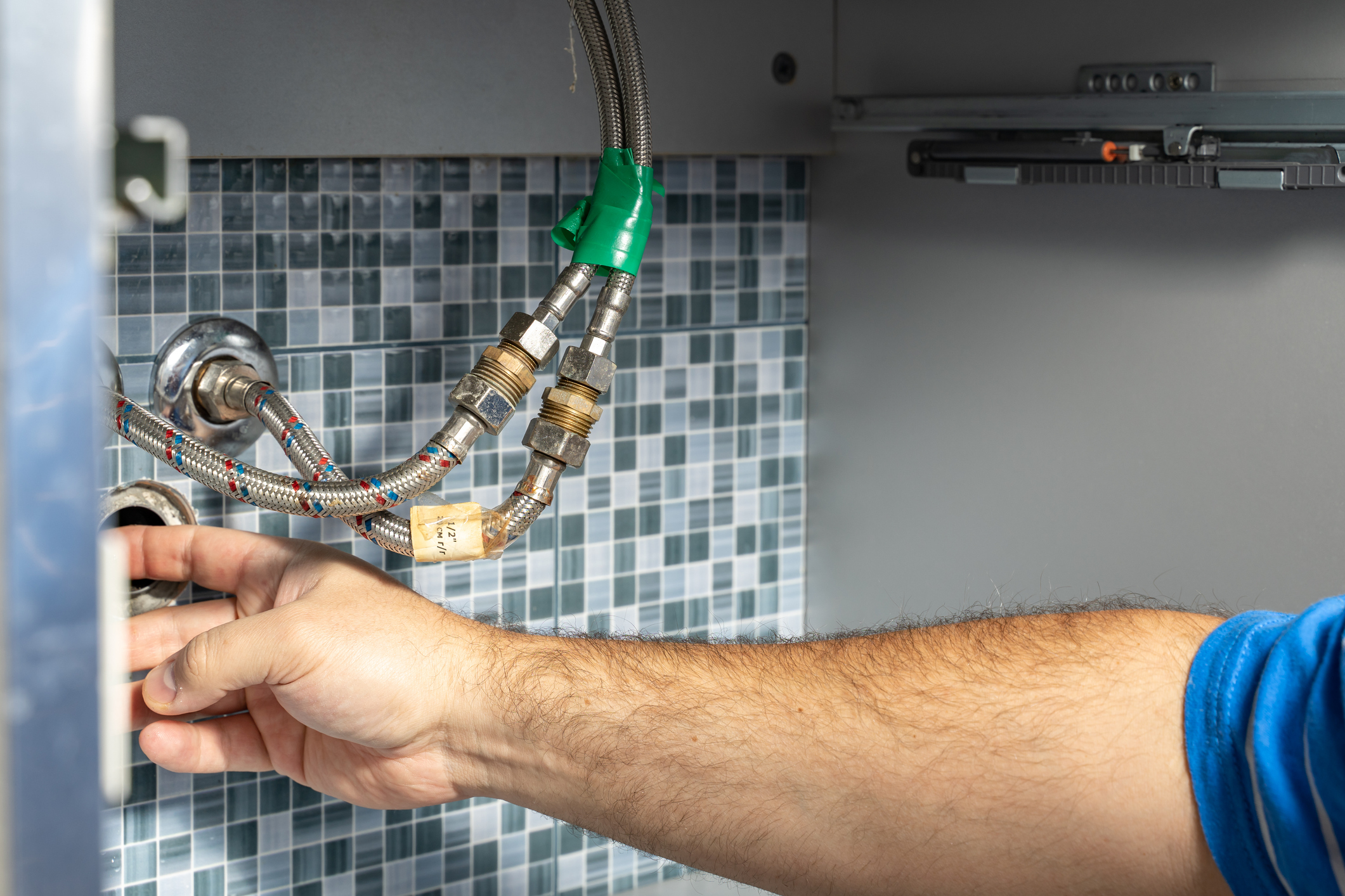 The plumber removes the blockage in the pipes.