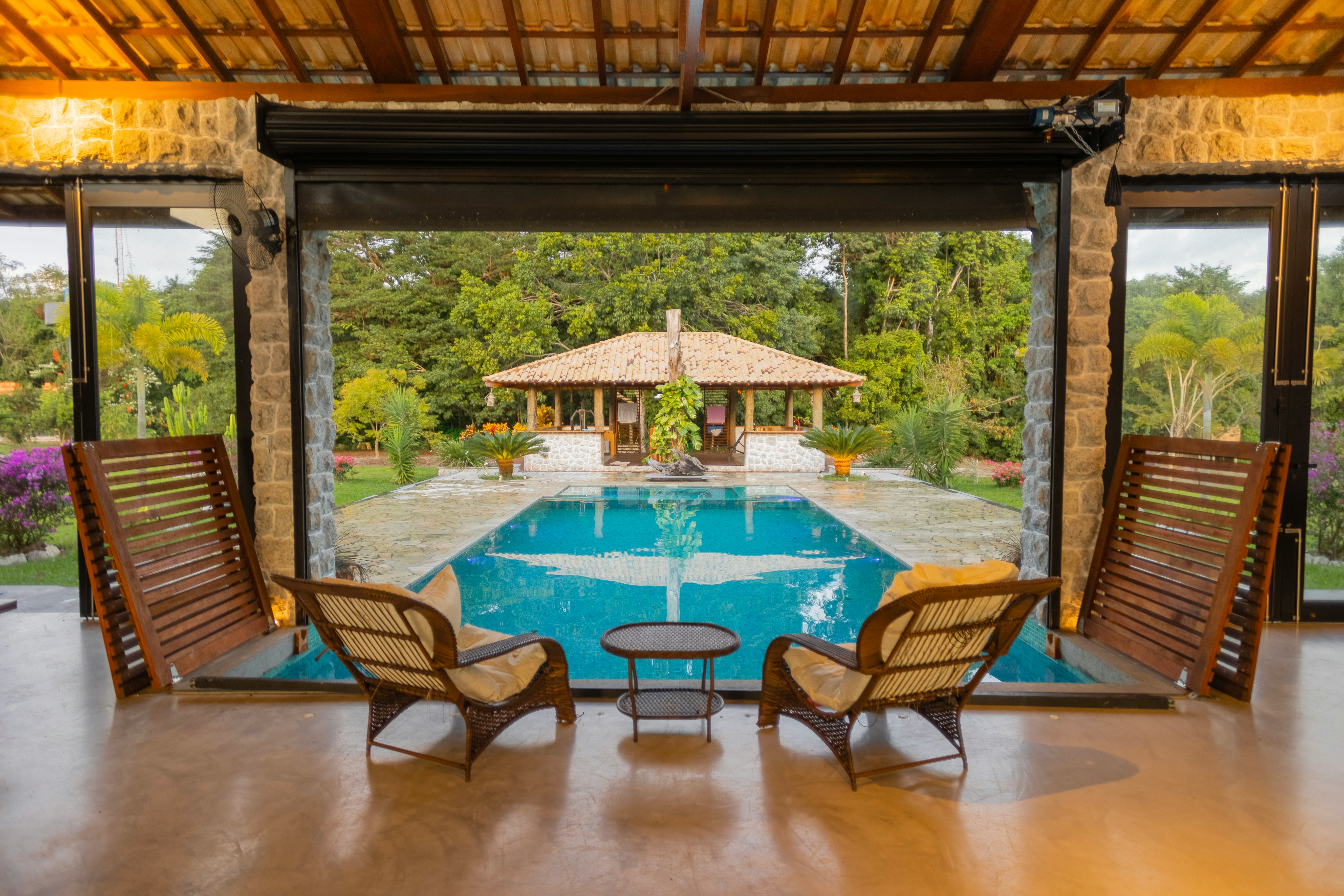 Photo of a hotel balcony with chairs open with a view of the pool 