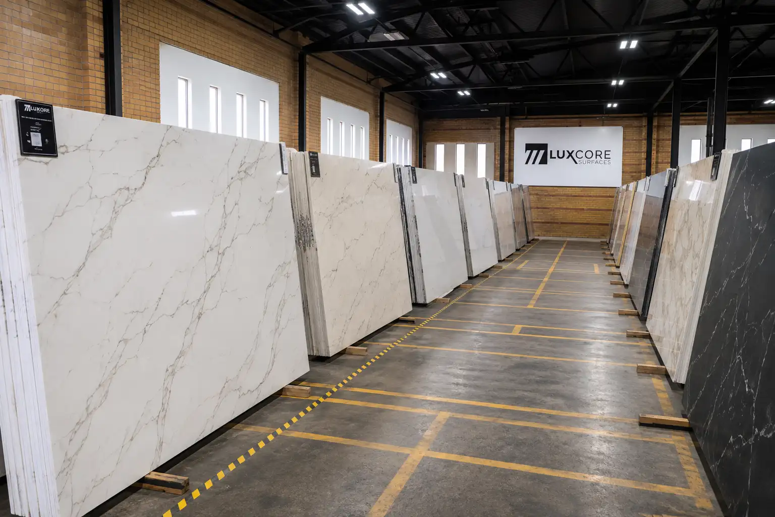Rows of quartz slabs displayed in the LuxCore Surfaces showroom for countertop selection