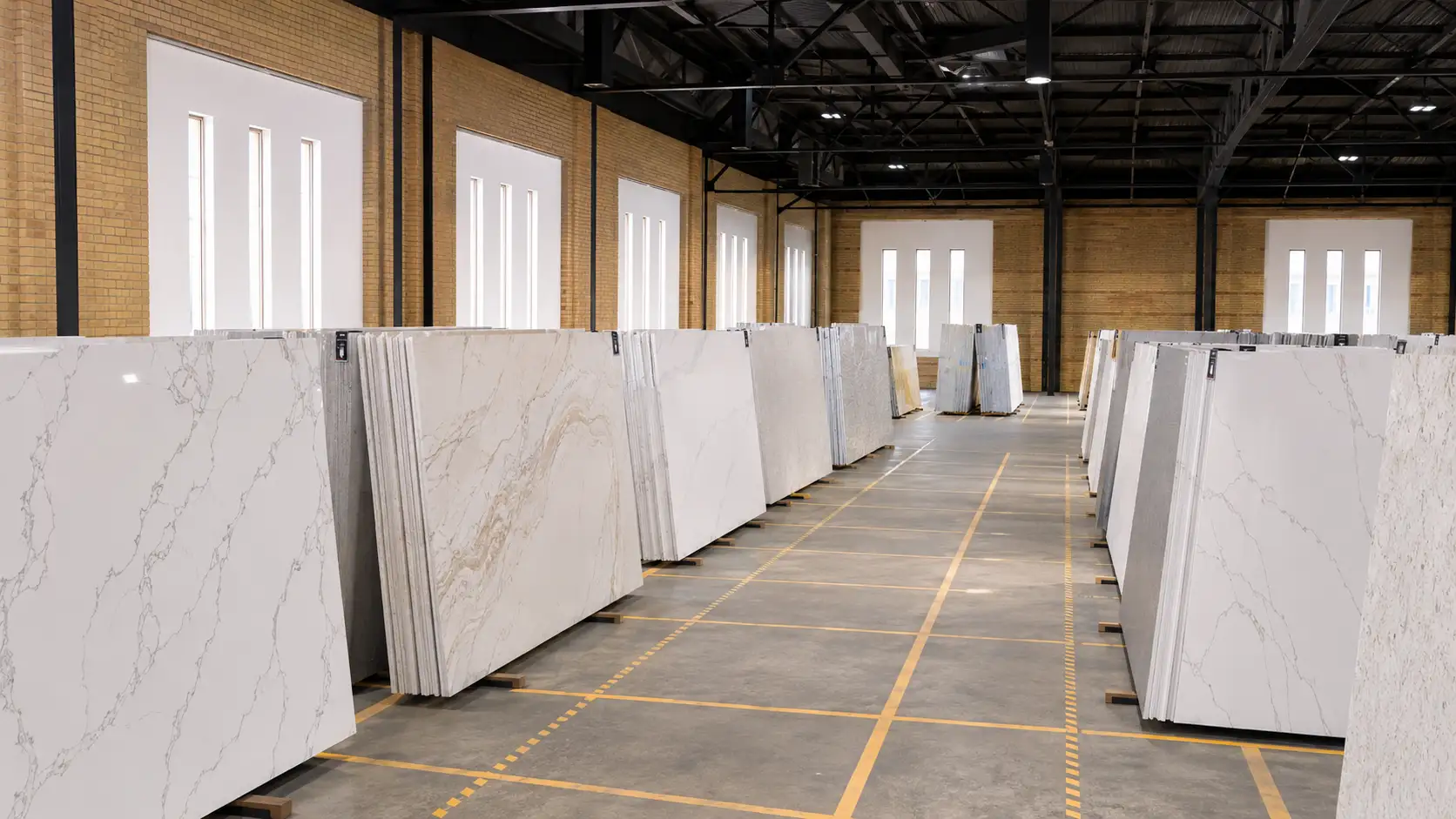 Quartz slabs arranged in a showroom selection area for homeowners comparing countertop patterns in person