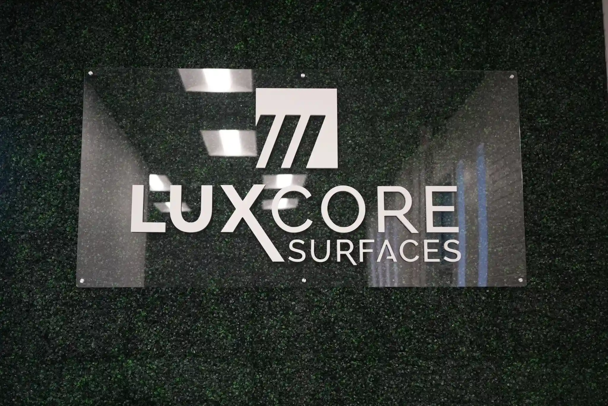 LuxCore Surfaces showroom signage for clients and designers visiting to compare quartz and natural stone slabs