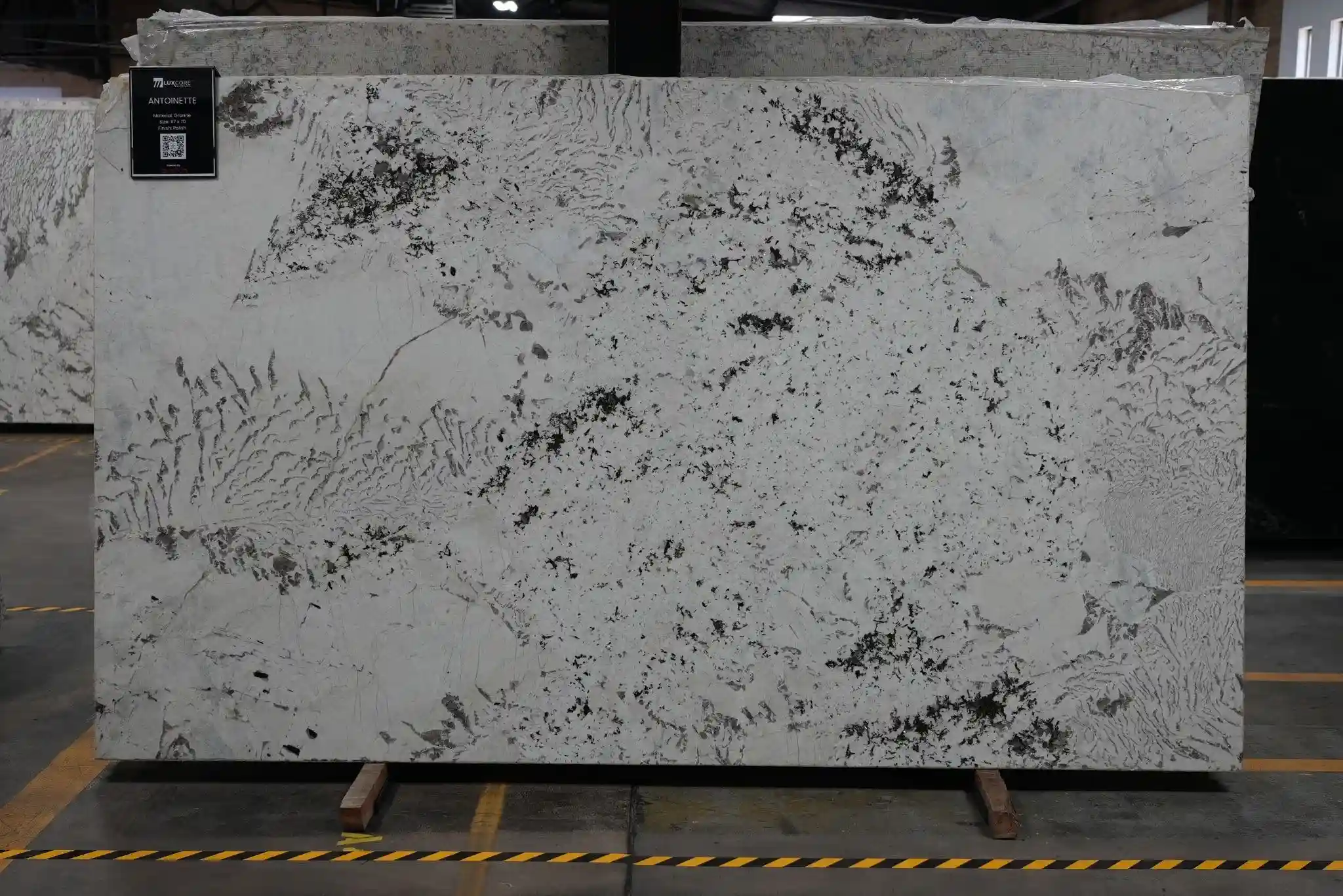 Full-size stone slab displayed in a showroom for clients evaluating material availability, movement, and project fit