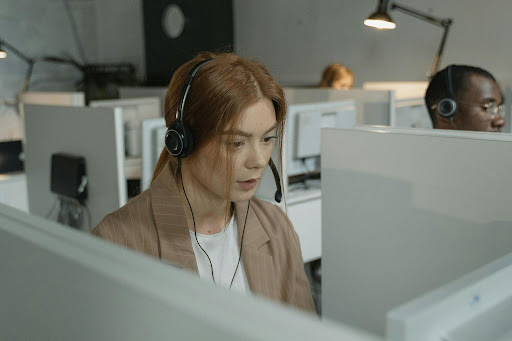 Customer service agent answering calls in a modern office using a headset