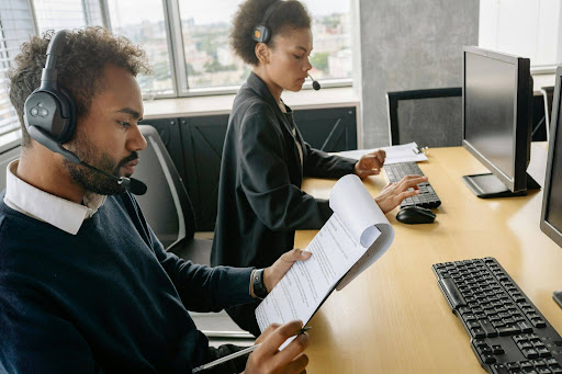 Dental answering service agents managing patient calls and appointment scheduling in a modern office environment