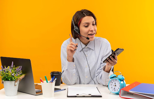 Customer service agent with headset answering business calls at modern support desk