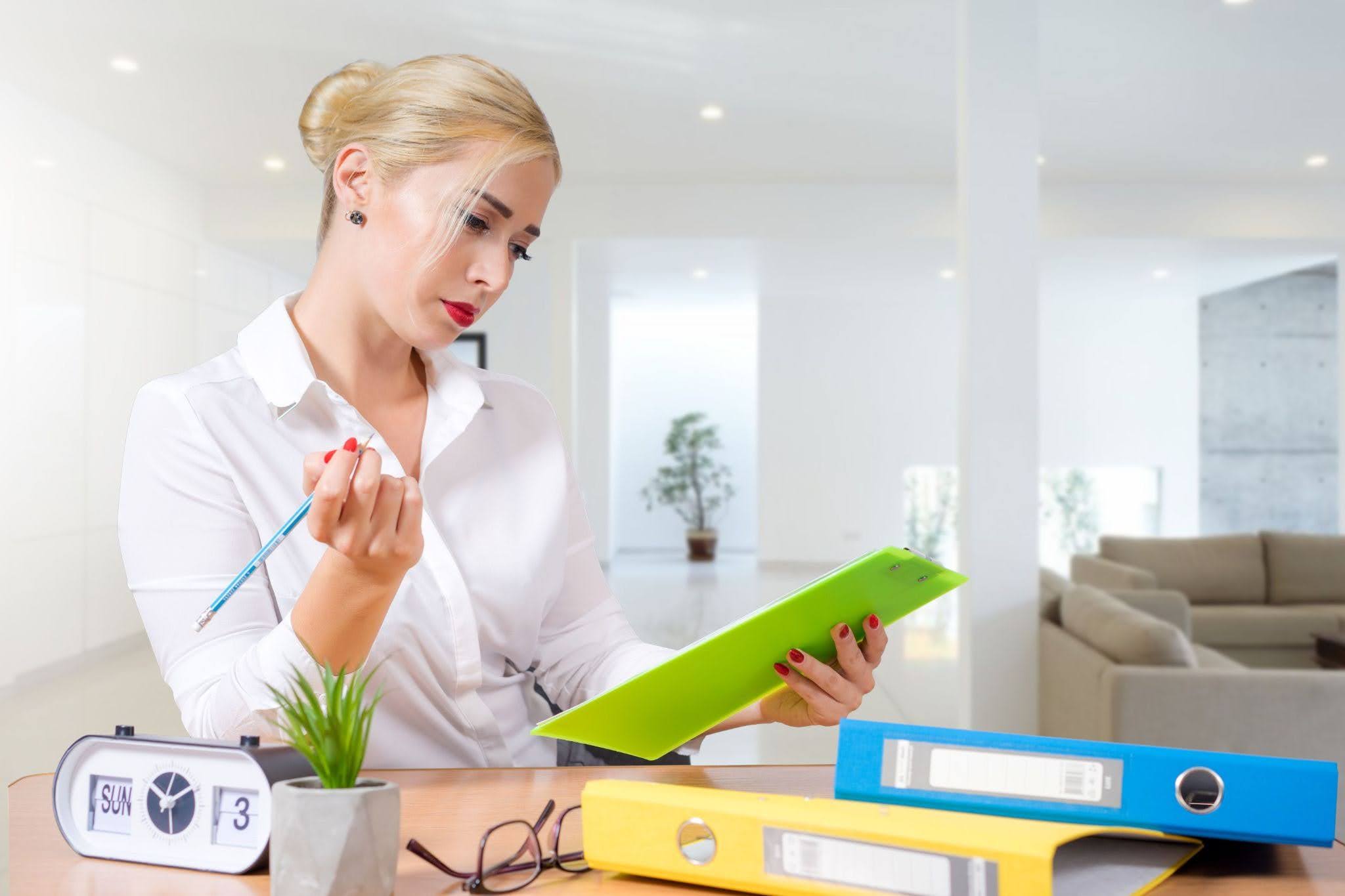 Business professional reviewing documents for virtual receptionist services