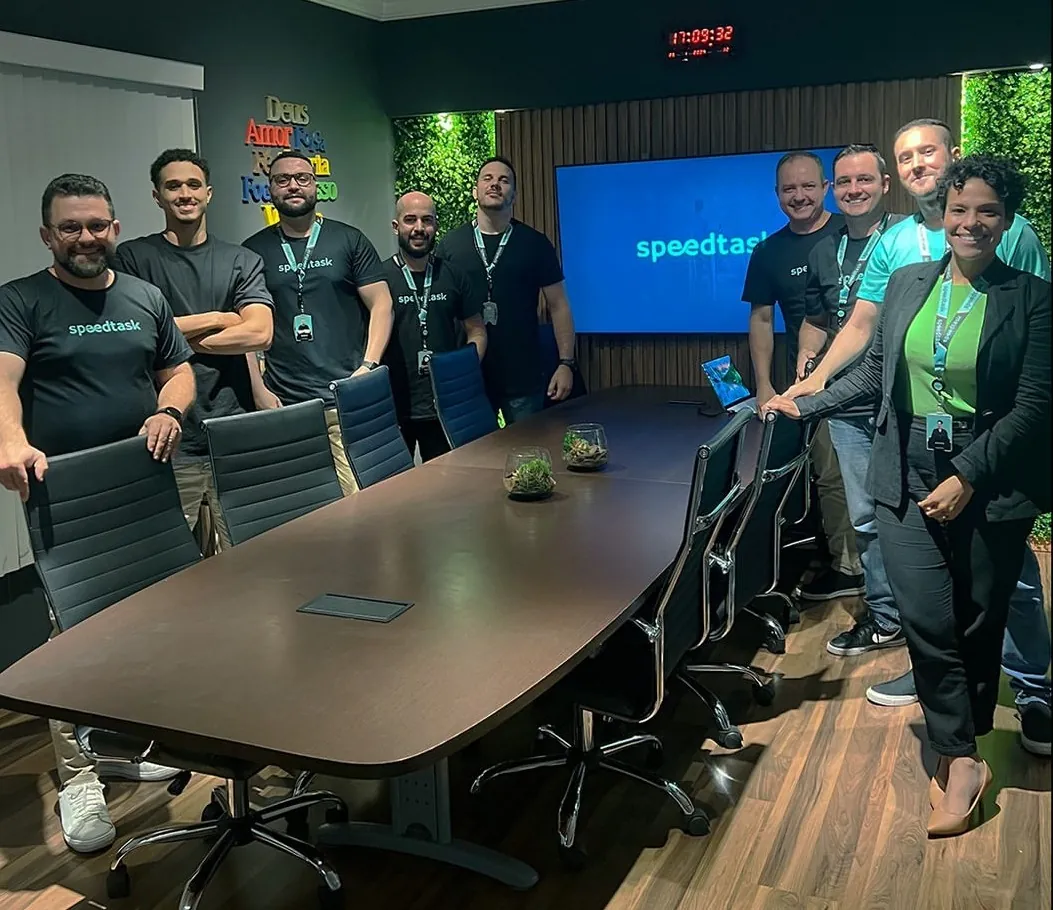Equipe da Speedtask reunida na sala de reuniões da empresa