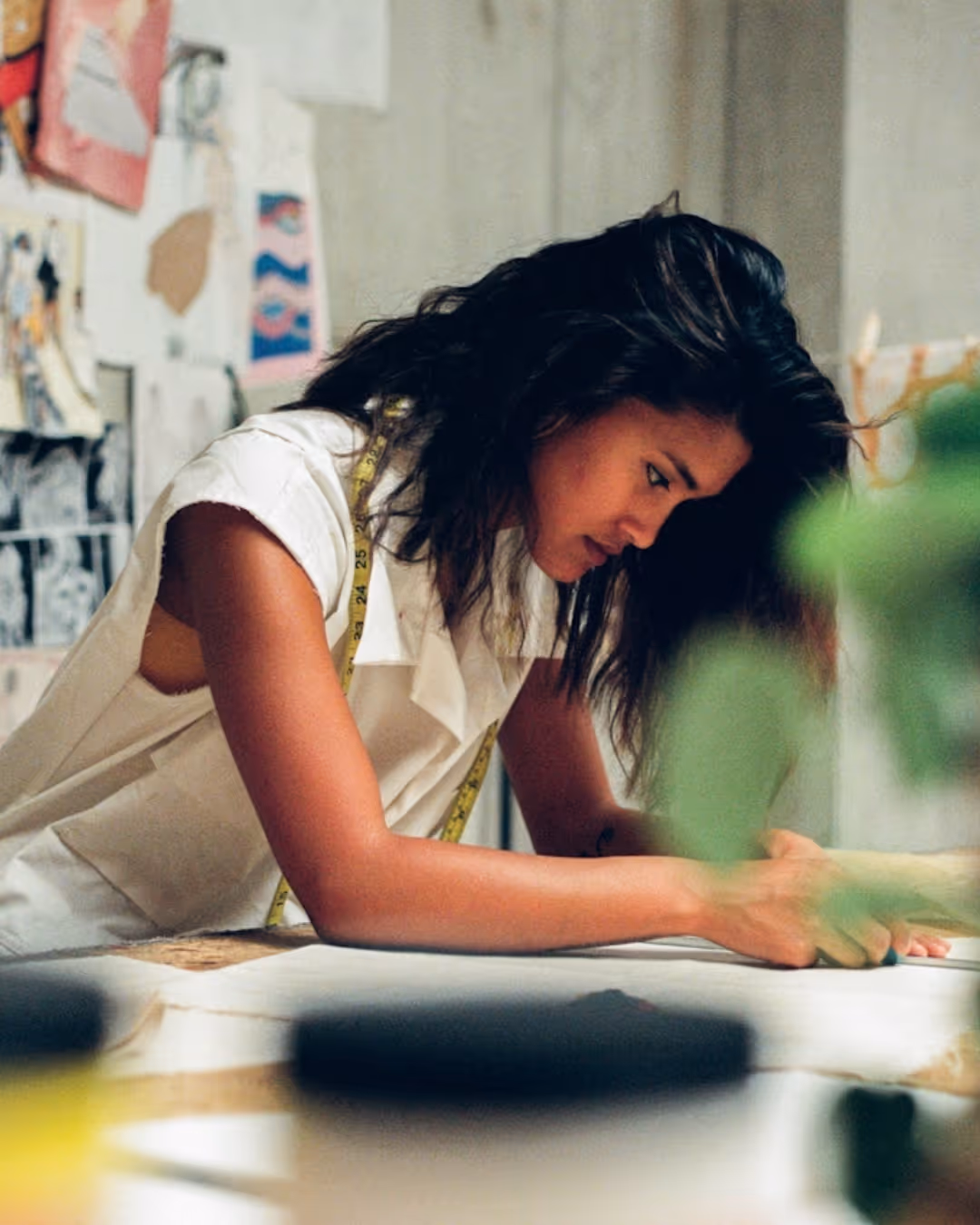 Aerial shot of several people collaborating at shared desk with laptops and notebooks
