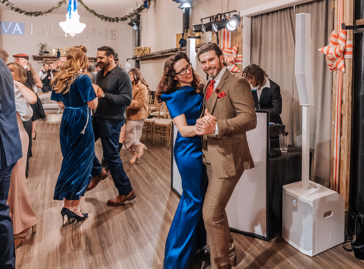 couple enjoying party at Bridal shop Greenville SC featuring luxury designer wedding gowns