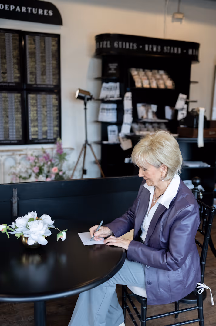 Loved ones writing notes inside a bridal shop Greenville SC during a wedding dress celebration