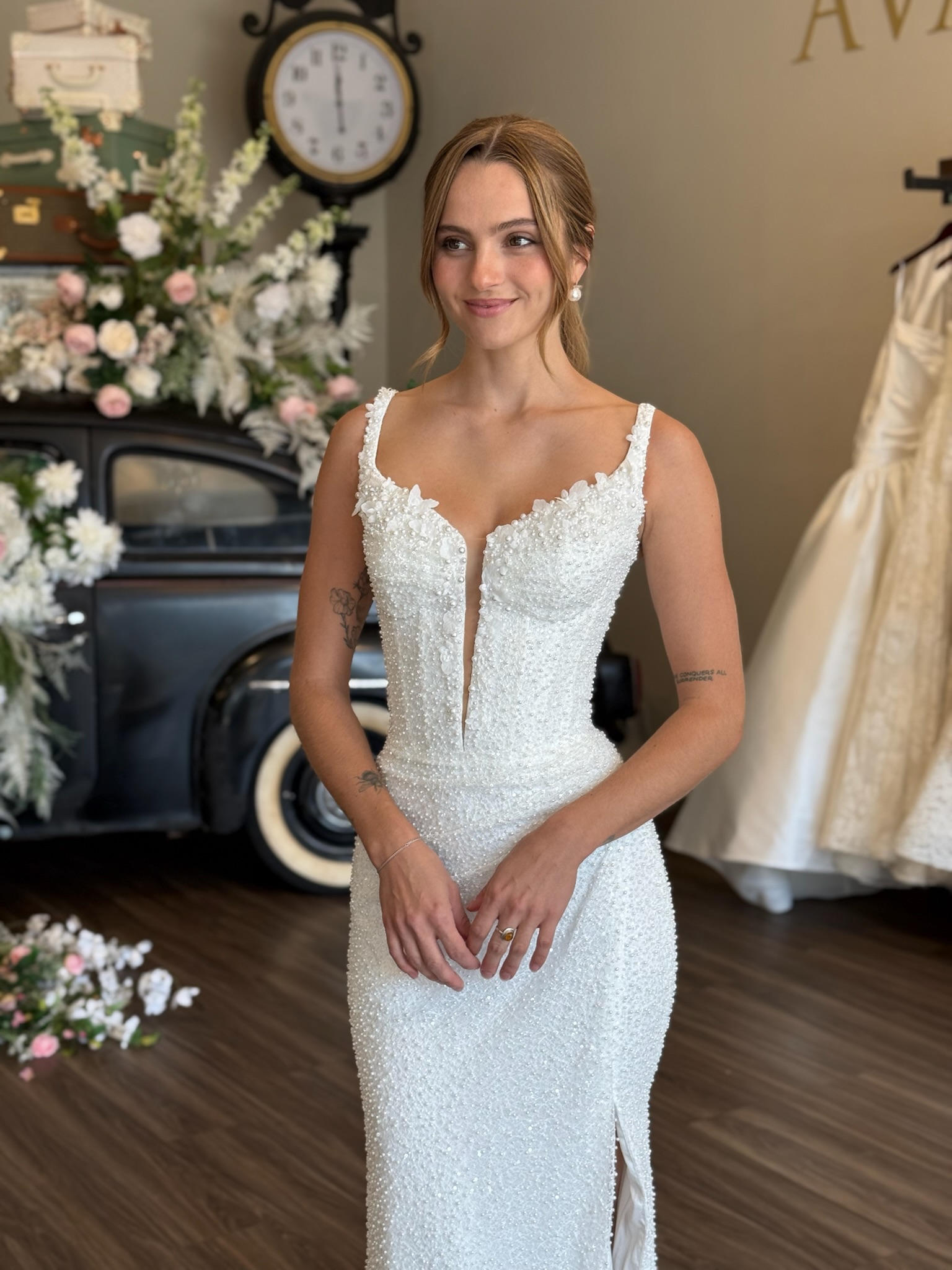 Elegant beaded fit and flare wedding gown with plunging neckline at luxury bridal boutique in South Carolina
