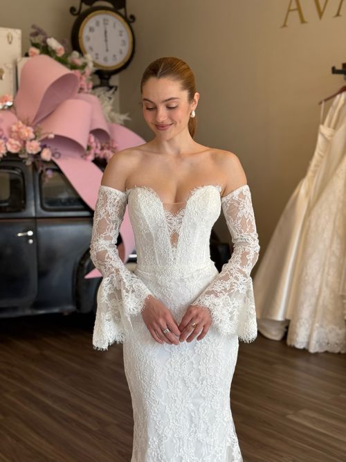 Romantic fitted lace wedding dress with illusion bodice and long sleeves in South Carolina bridal boutique
