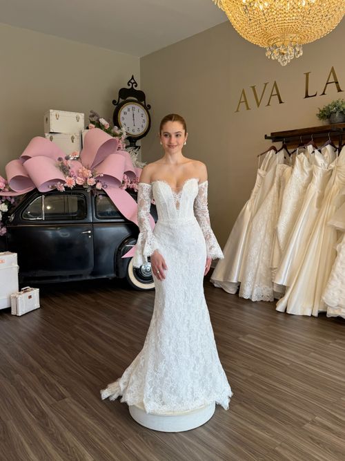 Romantic fitted lace wedding dress with illusion bodice and long sleeves in South Carolina bridal boutique