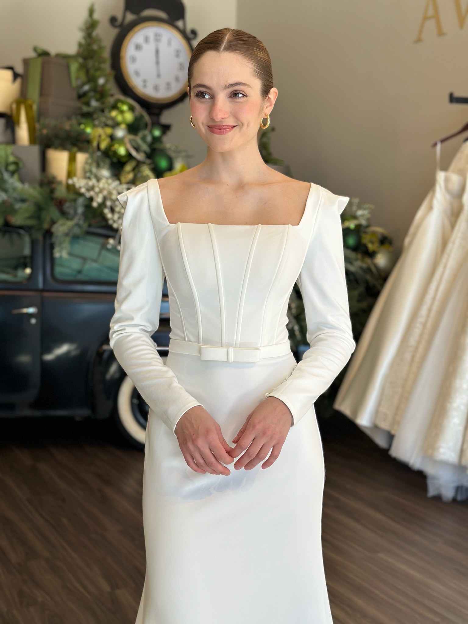 Elegant long sleeve square neckline wedding dress with structured bodice and minimalist silhouette