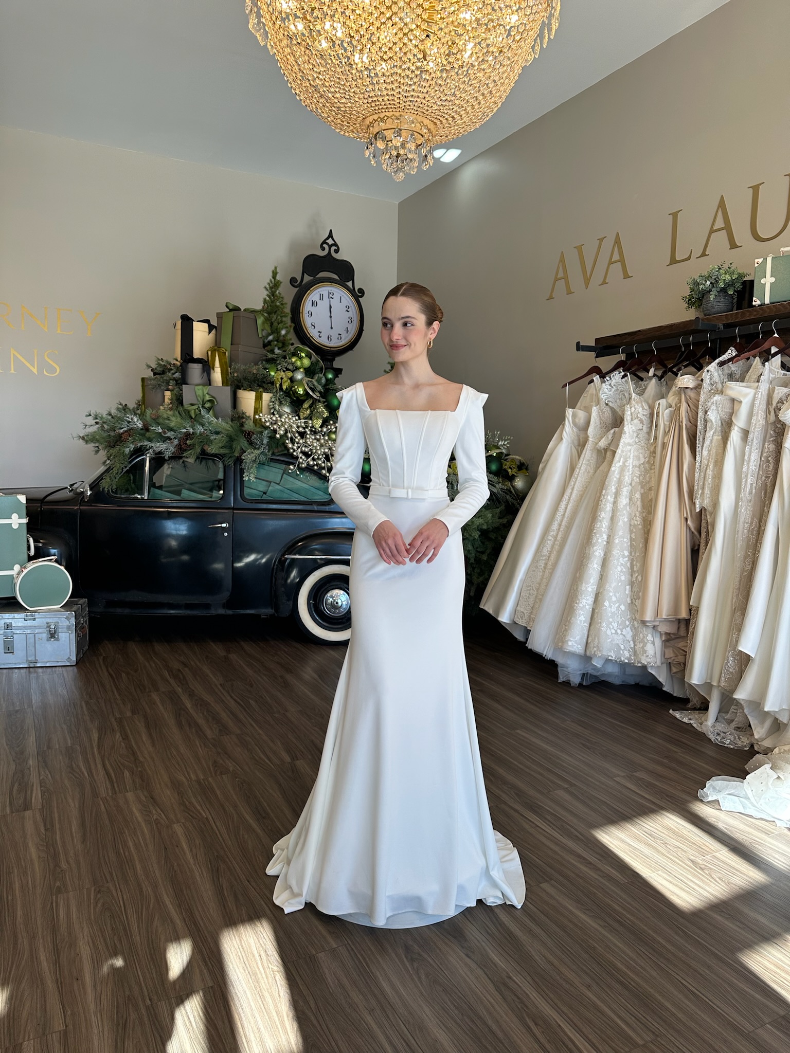 Elegant long sleeve square neckline wedding dress with structured bodice and minimalist silhouette