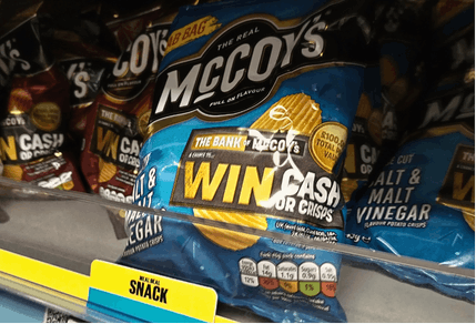 Promotional packs of McCoy's crisps on shelf.