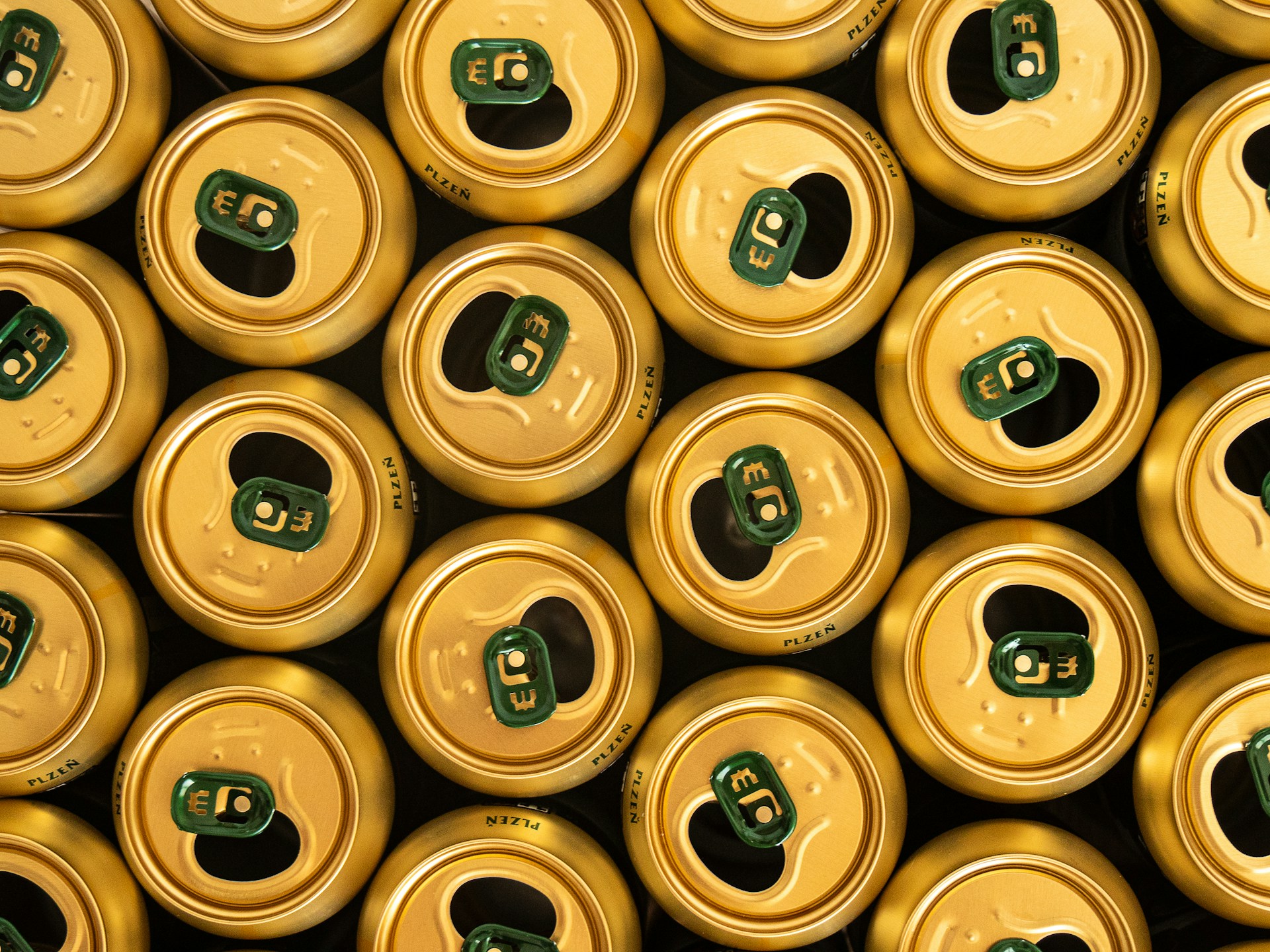 A group of golden beer cans seen from above.
