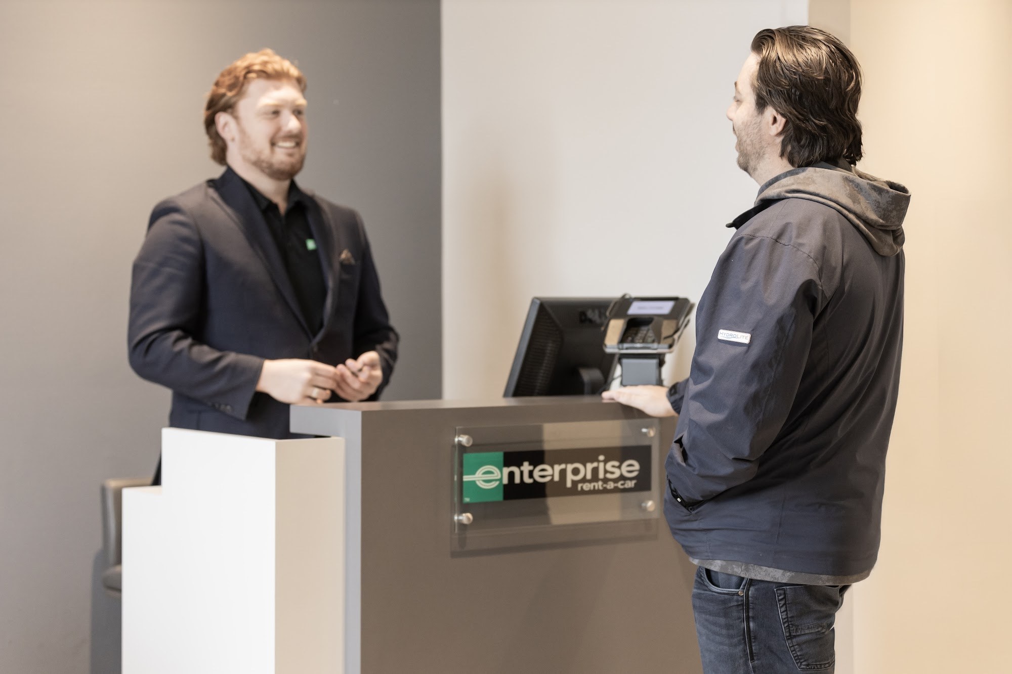 A customer at the on-site car rental counter at CSN 427 Auto in Etobicoke