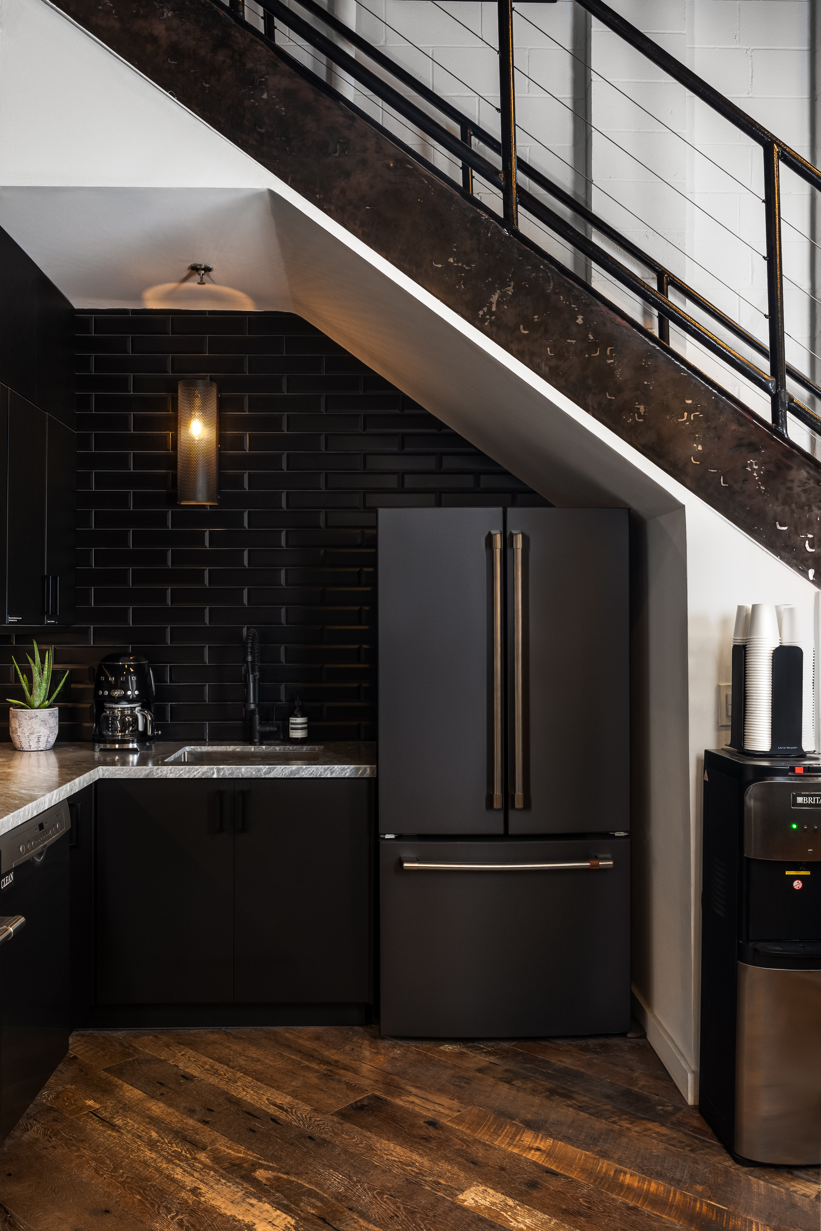 Kitchen area with stairs leading to upstairs area