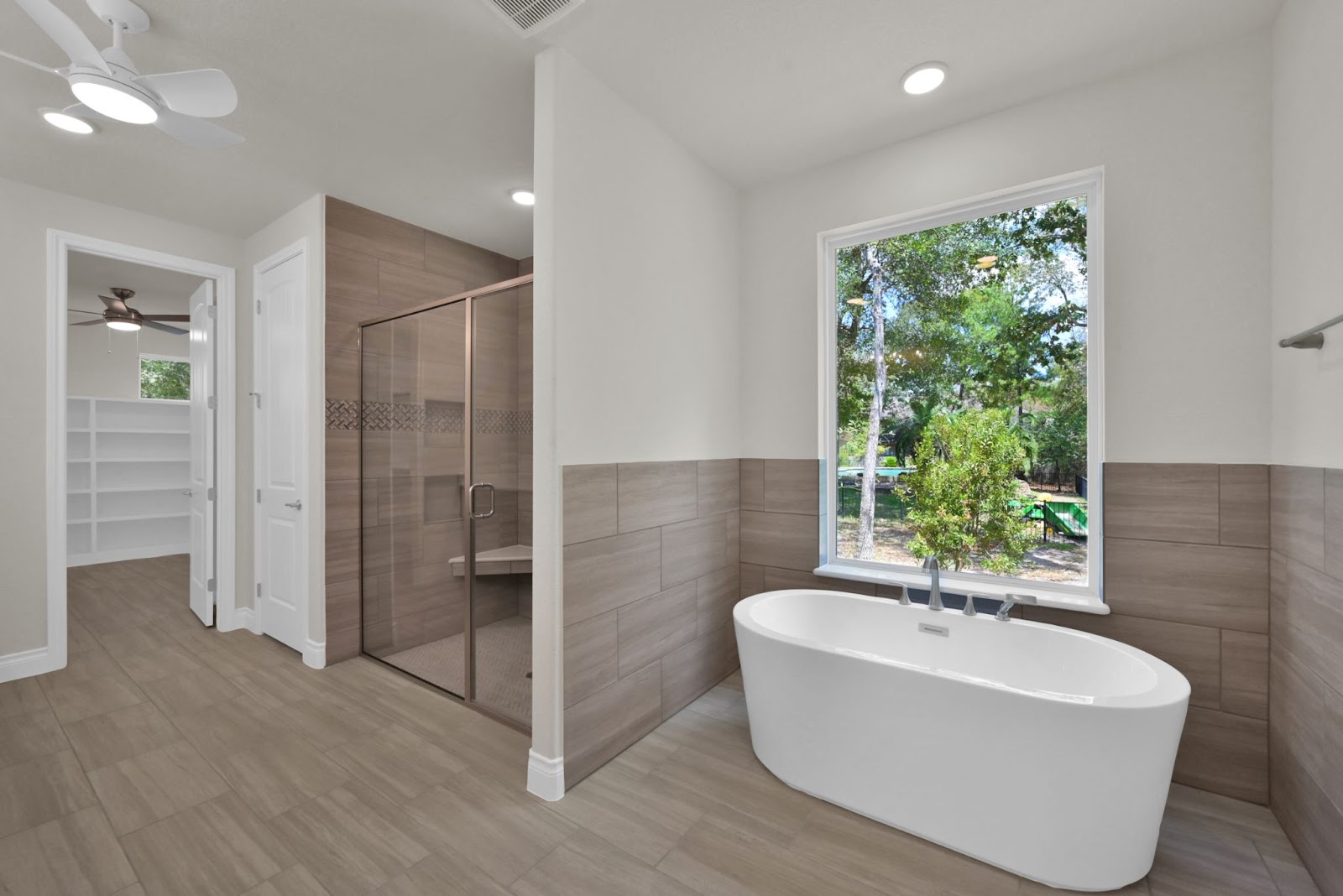 A modern bathroom built for accessibility with plenty of lighting and matte floor textures.