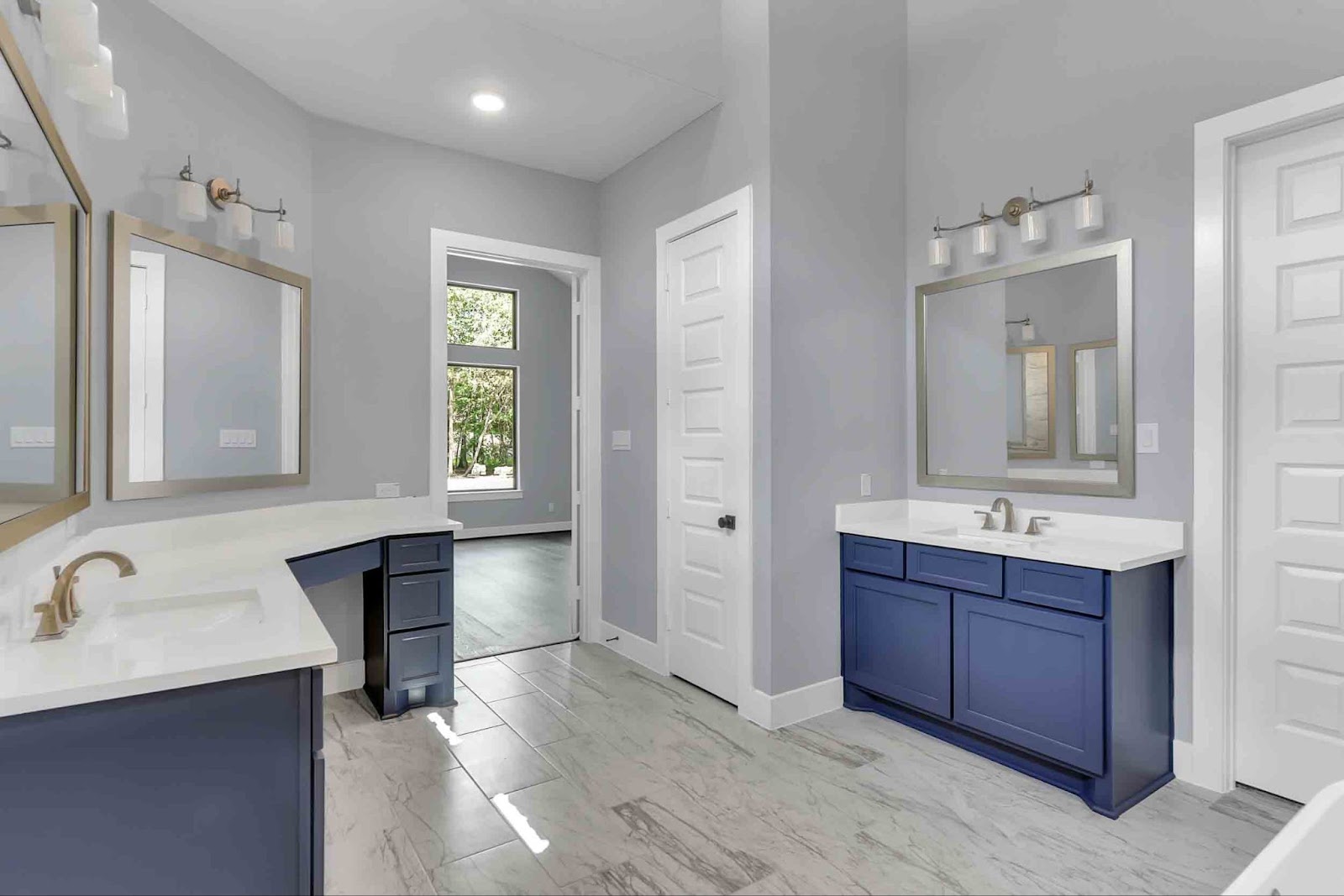 A sleek, modern bathroom with blue color accents on the cabinets