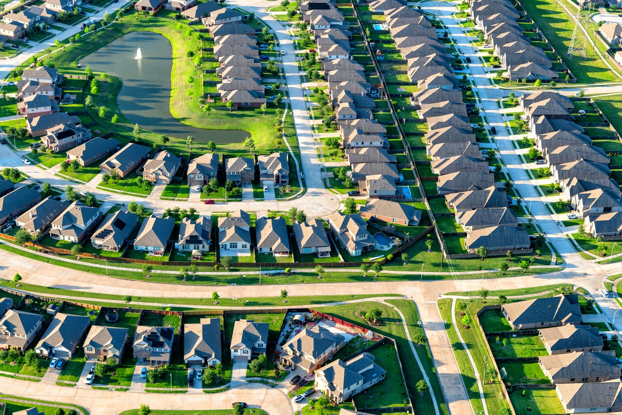 An aerial photo of a suburban neighborhood with rows of houses.