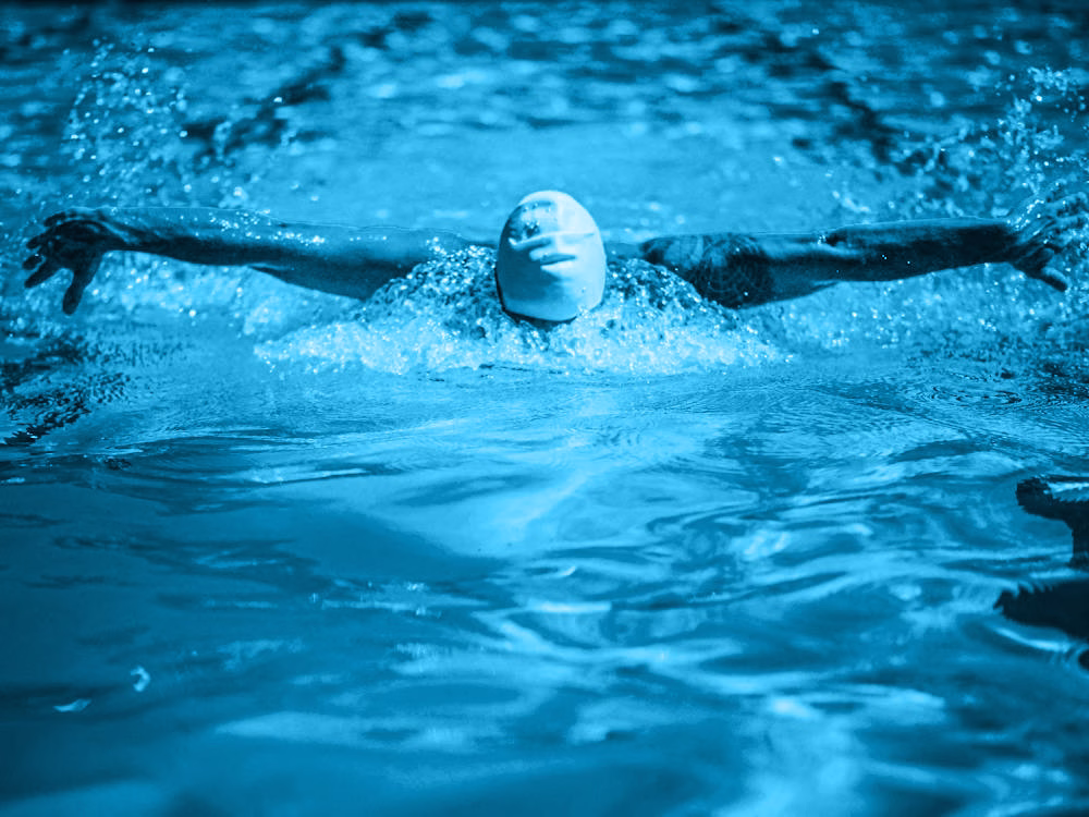 A swimmer performing a stroke in a pool.